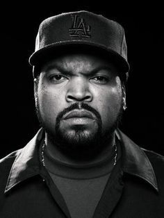 a black and white photo of a man wearing a baseball cap with the word la on it