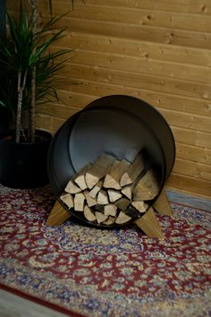 a pot with firewood in it sitting on the floor