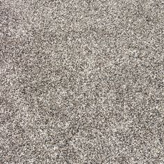 the texture of an area rug is shown in black and white colors, with small speckles on it