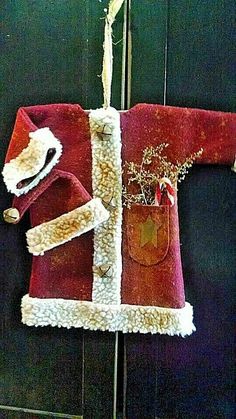 a red and white christmas sweater hanging on a wall