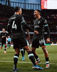 two soccer players are congratulating each other on the field