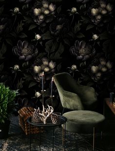 a chair and table in front of a wallpapered background with flowers on it