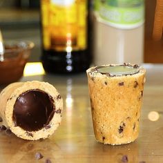 there is a chocolate chip cookie and a cupcake next to each other on the table