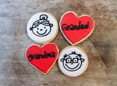 three decorated cookies with children's faces and the word grandma written on each cookie