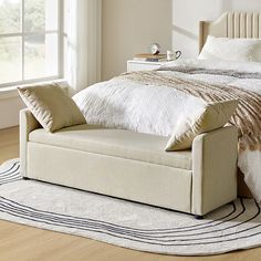 a white bed sitting on top of a wooden floor