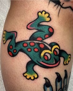 a colorful lizard tattoo on the leg