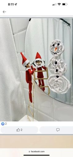 an image of two elfs in front of a mirror with snowmen on it