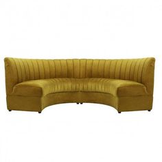 the curved couch is made from yellow velvet and has two legs that are extended to one end