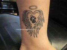 a heart with wings and an angel's paw tattoo on the ankle is shown