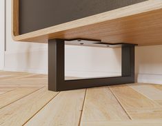 a close up of a wooden floor with a black frame on the bottom part of it