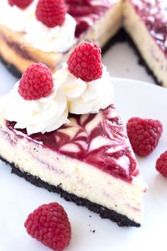 a slice of cheesecake with raspberries on top