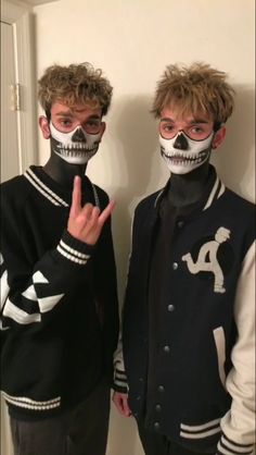 two young men with painted faces standing next to each other