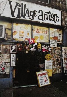 a store front with various items on display in it's glass window and sign that says village arts