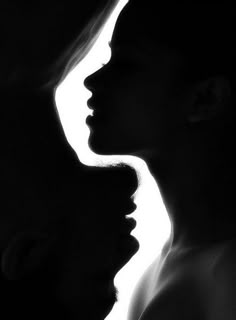 the silhouette of two women are shown in black and white