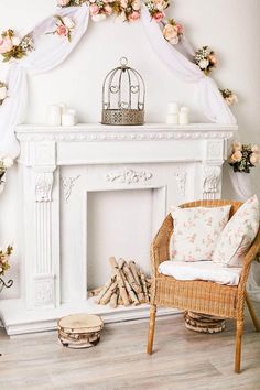 a white fireplace decorated with flowers and candles