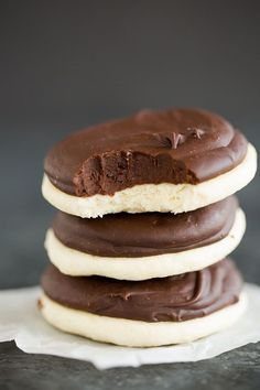 three chocolate covered cookies stacked on top of each other