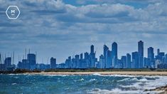 a city skyline is seen from the ocean