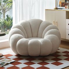 a white chair sitting on top of a checkered floor