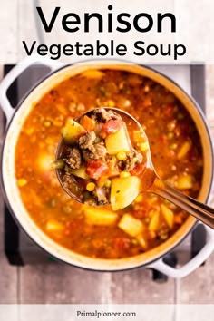 a spoon full of vegetable soup with the title overlay reads, venison vegetable soup