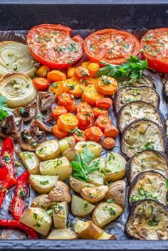 an assortment of vegetables are laid out on a tray to be grilled and served