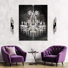 two purple chairs and a chandelier in a room