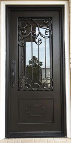 a black front door with wrought iron designs