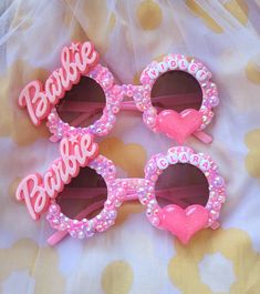 three pink sunglasses with the word barbie on them