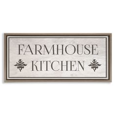 a sign that says farmhouse kitchen on the side of a white wall with black lettering