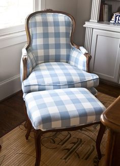 a blue and white checkered chair sitting in front of a window