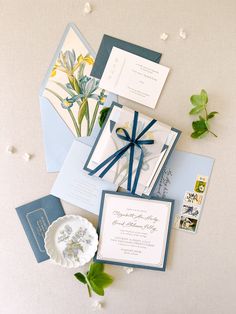 the wedding stationery is laid out on top of each other, including cards and envelopes