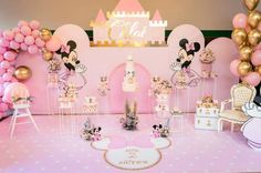 a pink and gold minnie mouse themed birthday party with balloons, decorations, and cake