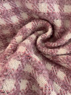 a close up view of a pink and white checkerboard pattern on a fabric