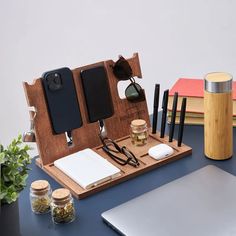 an open laptop computer sitting on top of a desk next to other office supplies and accessories