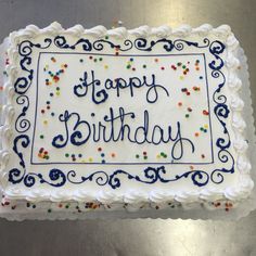 a birthday cake with white frosting and blue icing that reads, happy birthday