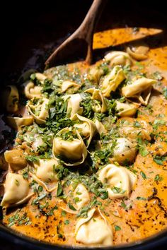 a pot filled with dumplings and garnished with parsley