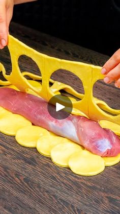 a person cutting up some food on top of a wooden table