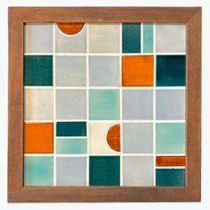 a wooden frame with an orange, blue and green tile pattern