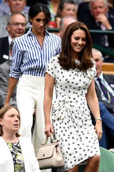 the duke and princess of cambridge are walking in front of spectators at a tennis match