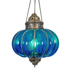 a blue glass light hanging from a chain