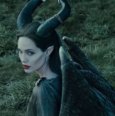 the maleficent character is dressed in black with horns