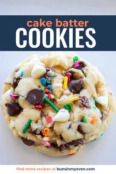 a cookie with chocolate chips and sprinkles on it, in front of the words cake batter cookies