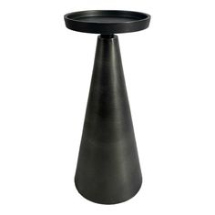 a black vase sitting on top of a table