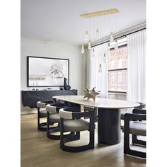 the dining room table is surrounded by modern chairs