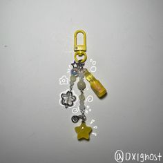 a yellow key chain with charms attached to it