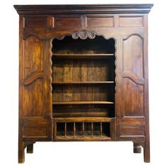 an old wooden bookcase with two doors and three shelves on the front, one door open