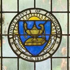 a stained glass window with an emblem on it