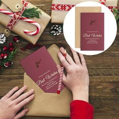 a person is wrapping christmas presents in brown paper