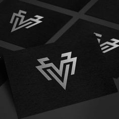 four black and white business cards with the letter v on them, all in different shapes