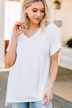 This versatile v-neck tee is here to make your life easy! It's honestly the perfect top for year round styling and layering. You can knot the hem or half tuck into your favorite jeans or shorts. You can layer it with all sorts of jackets, shackets, or kimonos. And don't even get us started on accessories! The options are absolutely endless! This top is truly a staple piece! This top features a v neckline, short cuffed sleeves, and a generous fit. Material has generous amount of stretch. Sydney i White Relaxed Fit V-neck Top, Chic White V-neck T-shirt, White Short Sleeve V-neck Top For Everyday, White V-neck T-shirt For Day Out, White V-neck Short Sleeve Top, White V-neck Top For Everyday Spring Wear, White V-neck Top For Everyday Wear, Chic V-neck T-shirt For Layering, Chic V-neck T-shirt For Everyday