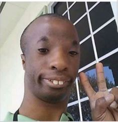 a man making the peace sign with his hand in front of a window and palm up